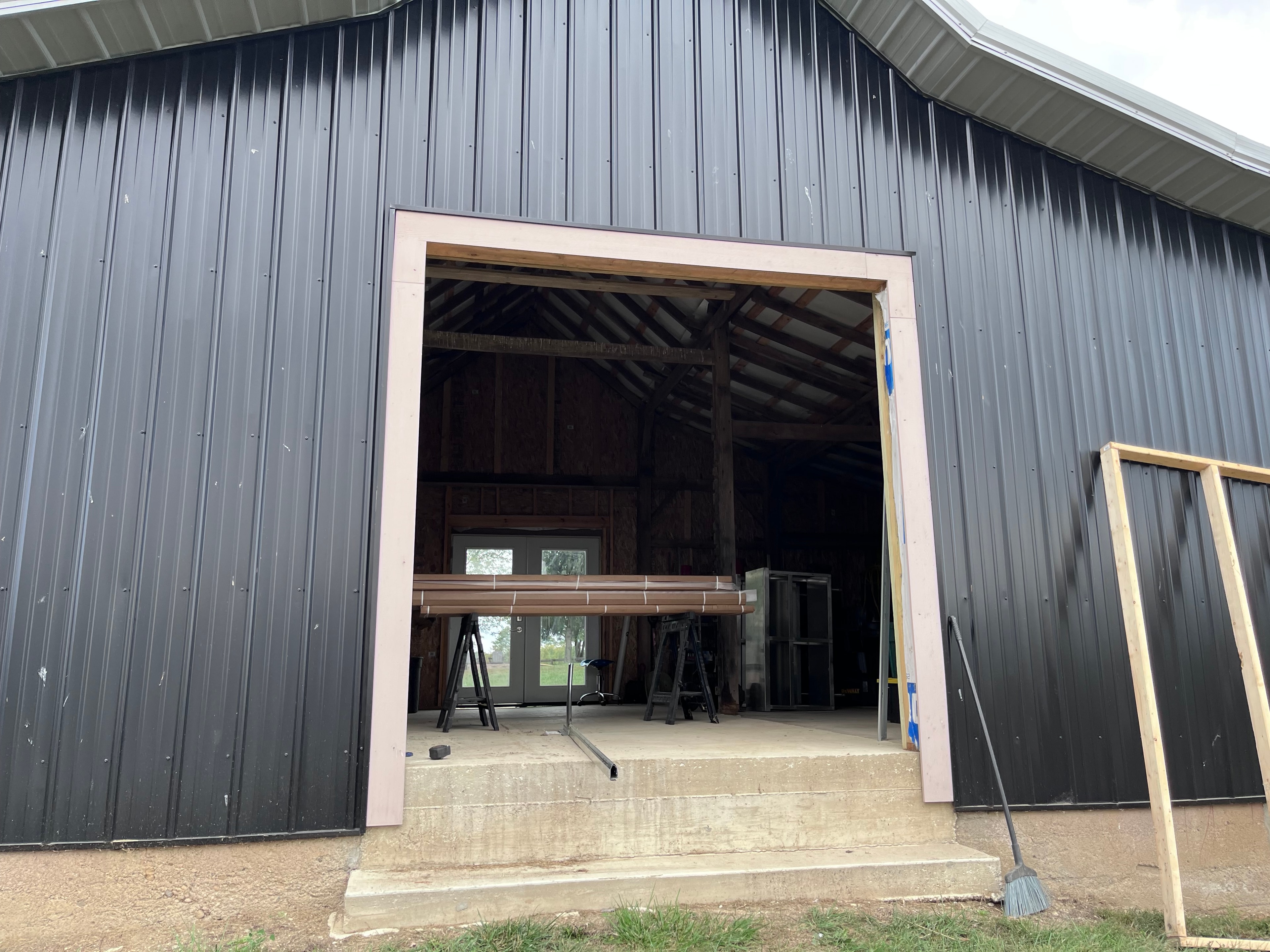 Garage door panels being installed in barn opening mid-installation
